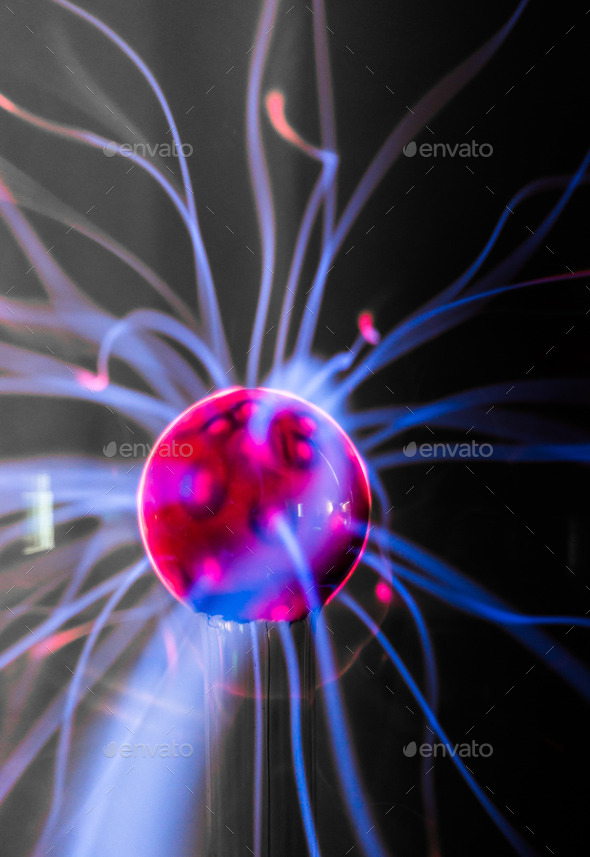 Plasma ball with magenta-blue flames isolated on a black background.