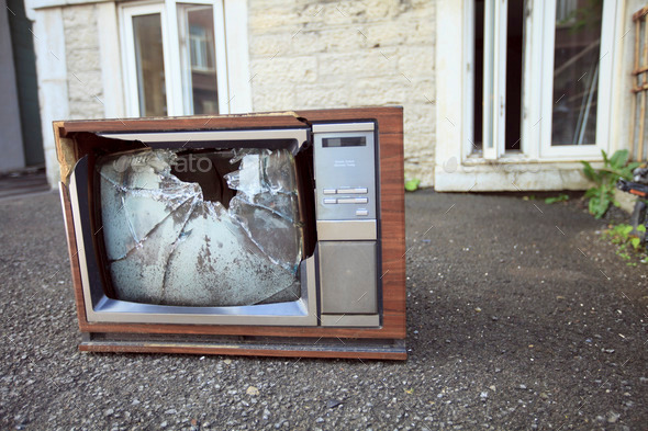 An old broken TV left on the street.