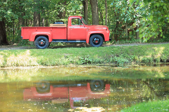 A old retro beautiful red truck in a park