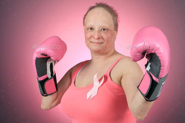 A Woman with boxing gloves ready to fight.