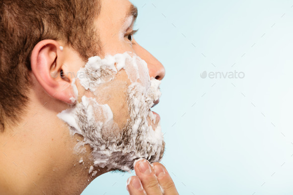 Man shaving beard face profile