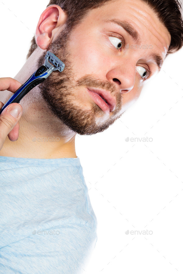 Young man with beard holding razor blade (Misc) Photo Download