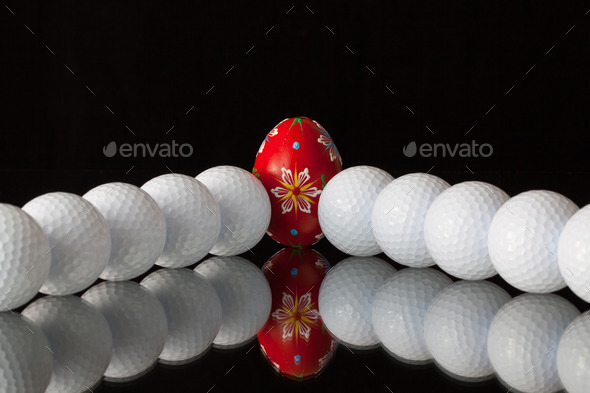Golf balls and egg on a black glass desk (Misc) Photo Download