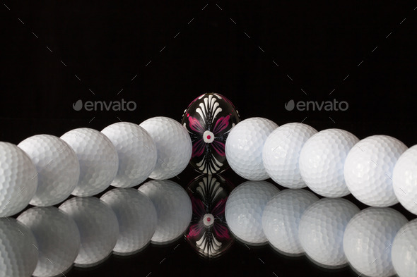 Golf balls and egg on a black glass desk (Misc) Photo Download