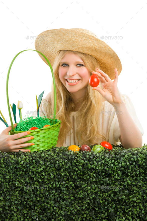 Girl finds a easter egg in the green grass. (Misc) Photo Download