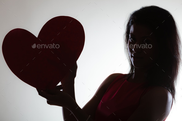 Girl mixed race with paper red heart (Misc) Photo Download