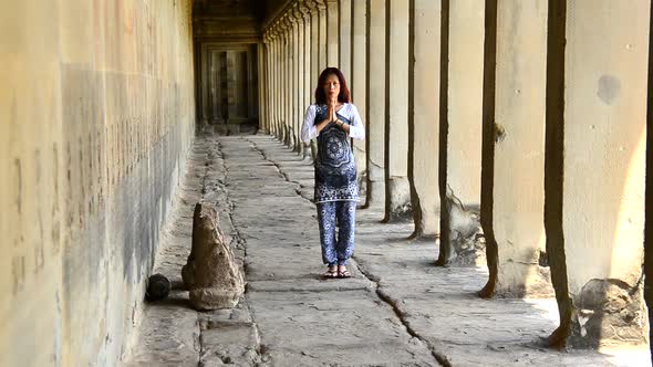 Female Buddhist With Hands In Prayer In Temple Hallway Angkor Wat Temple Cambodia Female Buddhist With Hands In Prayer In Temple Hallway Angkor Wat Temple Cambodia