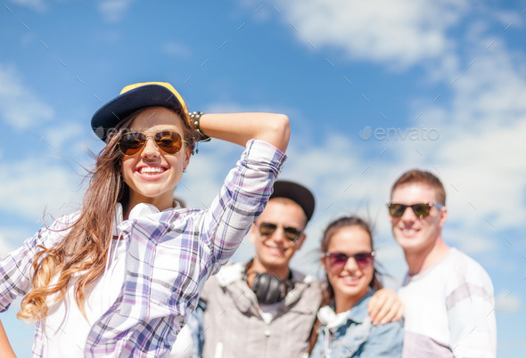 teenage girl with headphones and friends outside (Misc) Photo Download