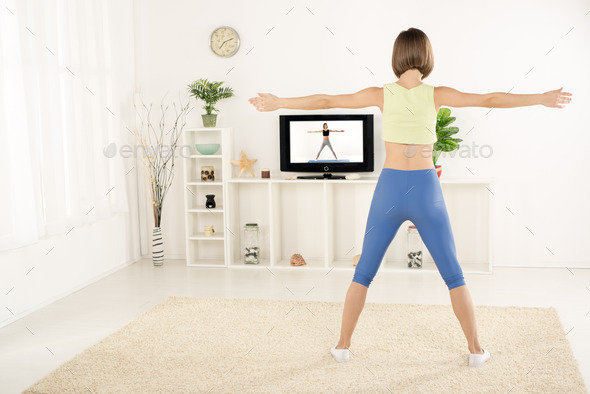 Young Woman Exercise In Front Of TV (Misc) Photo Download