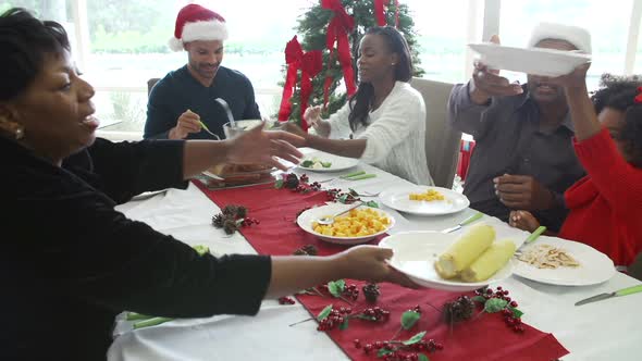 Multi-Generation Family Enjoying Christmas Meal Together 2