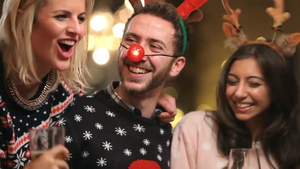 Group Of Friends Enjoying Christmas Drinks In Bar 1