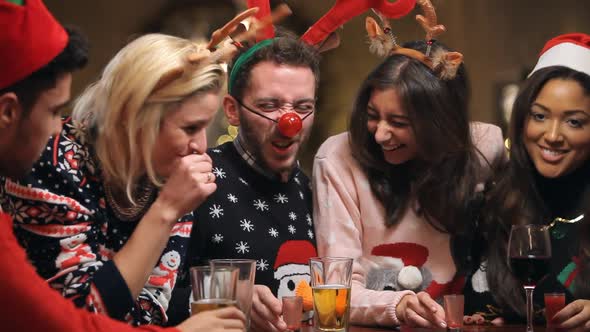 Group Of Friends Enjoying Christmas Drinks In Bar 2