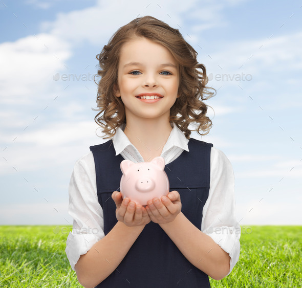happy girl holding piggy bank on palms