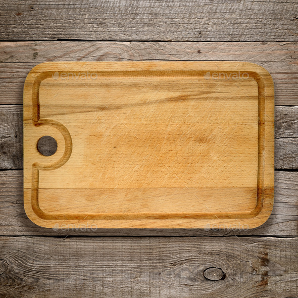 Chopping board on old wooden background