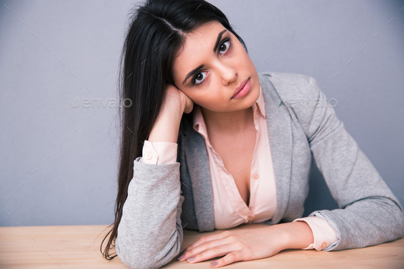 Young attractive woman sitting at the table (Misc) Photo Download