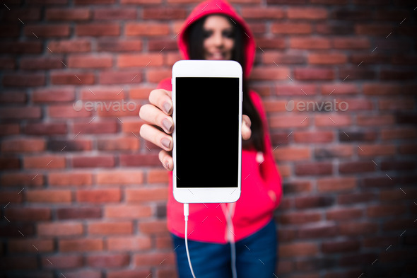 Woman showing blank smartphone screen (Misc) Photo Download