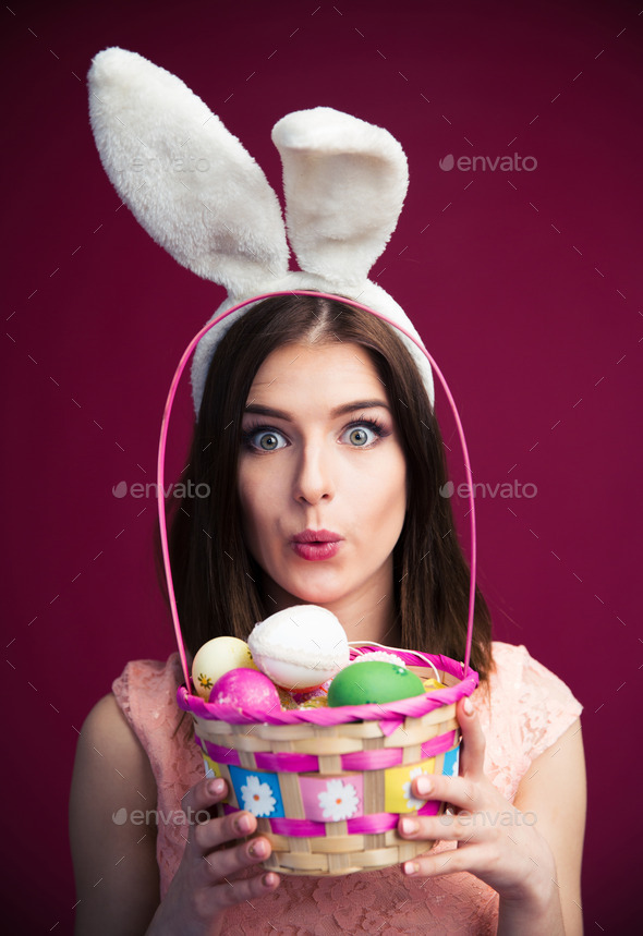 Cute young woman with an Easter egg basket (Misc) Photo Download