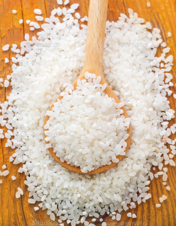 raw rice in the wooden spoon (Misc) Photo Download