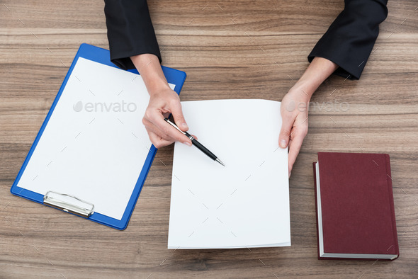 Closeup of a businesswoman's hands while checking some documents (Misc) Photo Download