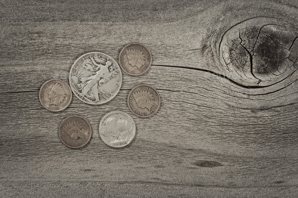 Concept of vintage coins on aged wood