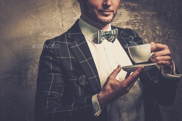 Sharp dressed fashionist with cup of coffee