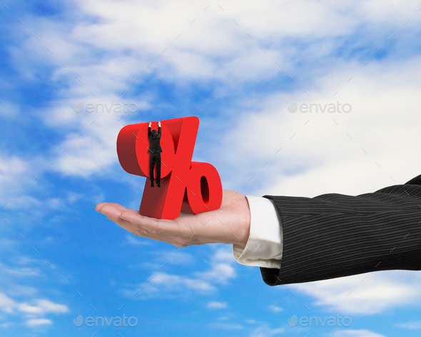 Hand showing businessman hanging on percentage sign with sky clouds (Misc) Photo Download