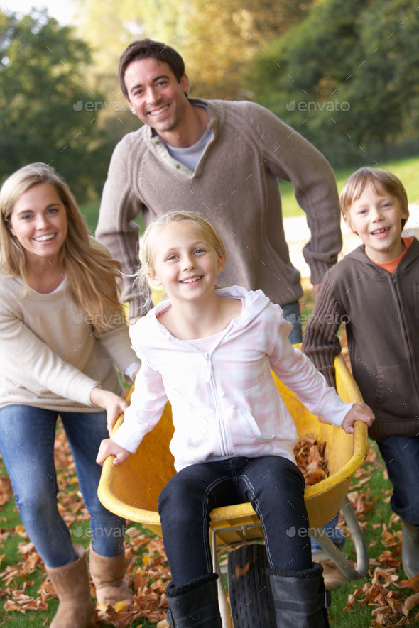 Family having fun with autumn leaves in garden (Misc) Photo Download