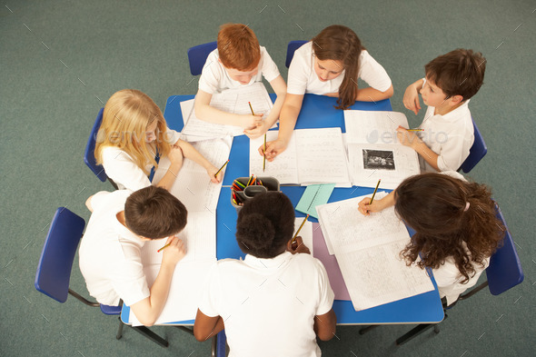 Overhead View Of Schoolchildren Working Together At Desk (Misc) Photo Download