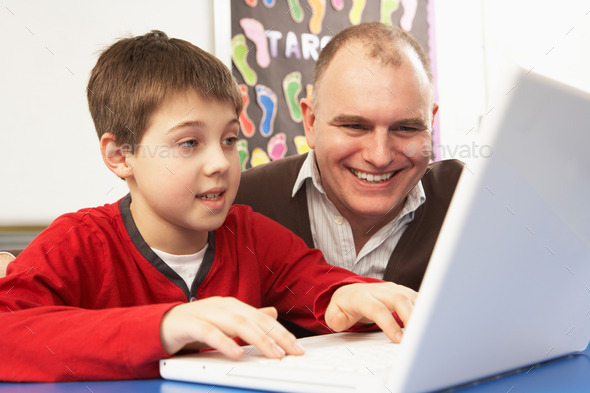 Schoolboy In IT Class Using Computer With Teacher (Misc) Photo Download