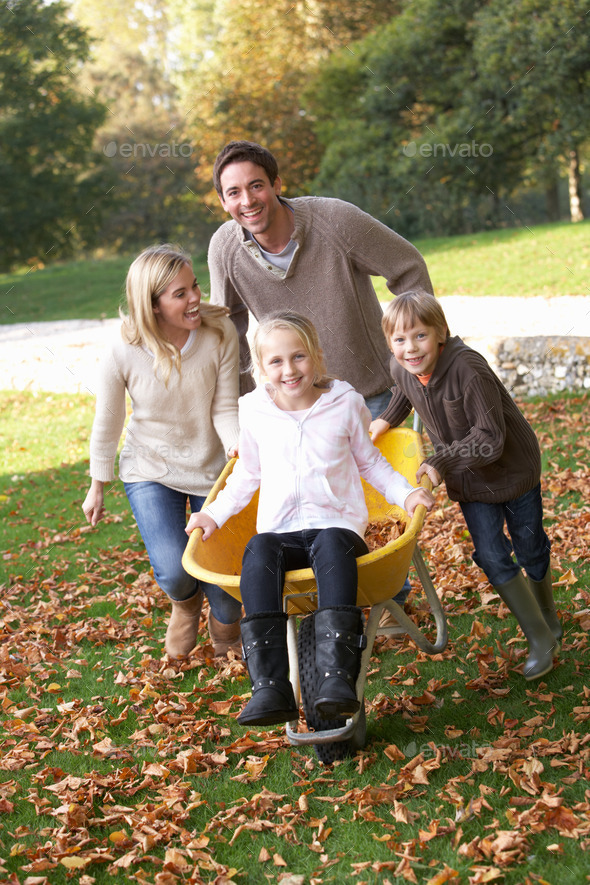 Family having fun with autumn leaves in garden (Misc) Photo Download