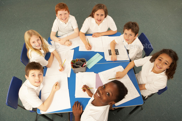 Overhead View Of Schoolchildren Working Together At Desk (Misc) Photo Download