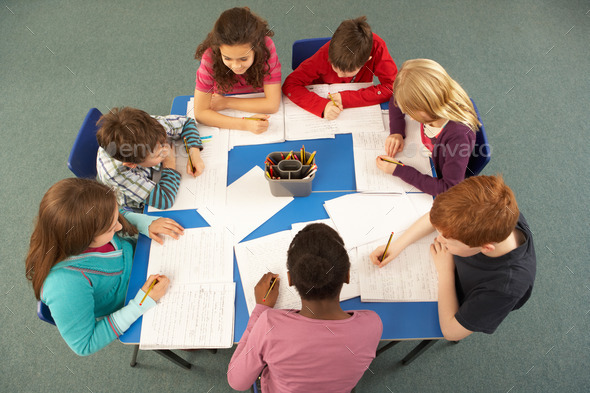 Overhead View Of Schoolchildren Working Together At Desk (Misc) Photo Download