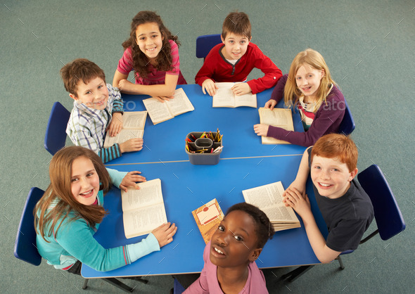 Overhead View Of Schoolchildren Working Together At Desk (Misc) Photo Download