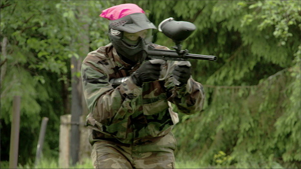 A Man Walking with the Shooting Paintball A Man Walking with the Shooting Paintball