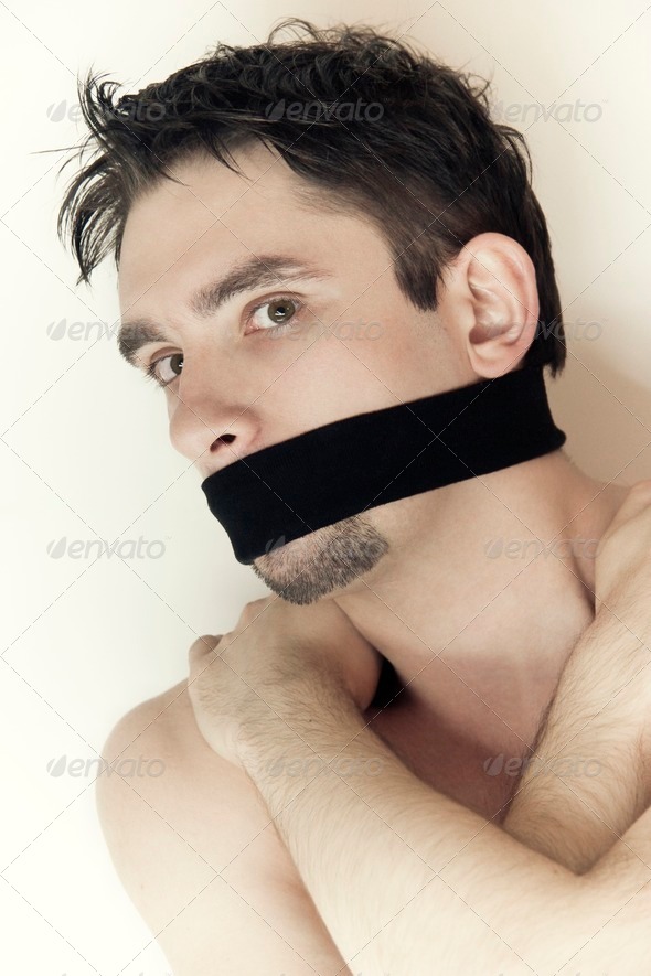scared young man with bandage on mouth close up