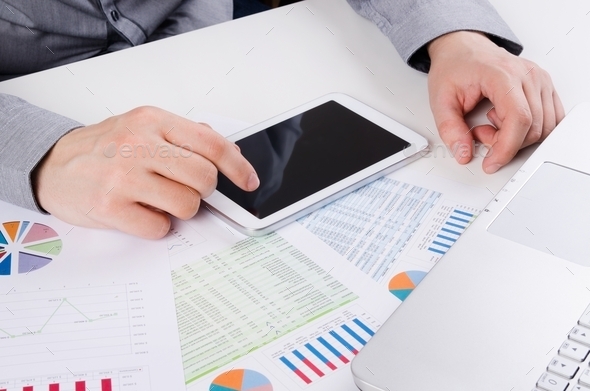 Businessman working with digital tablet. Report charts on desk (Misc) Photo Download