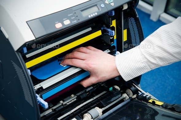 Man puts toner in the printer (Misc) Photo Download