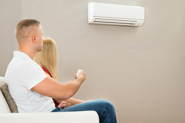 Couple Using Air Conditioner
