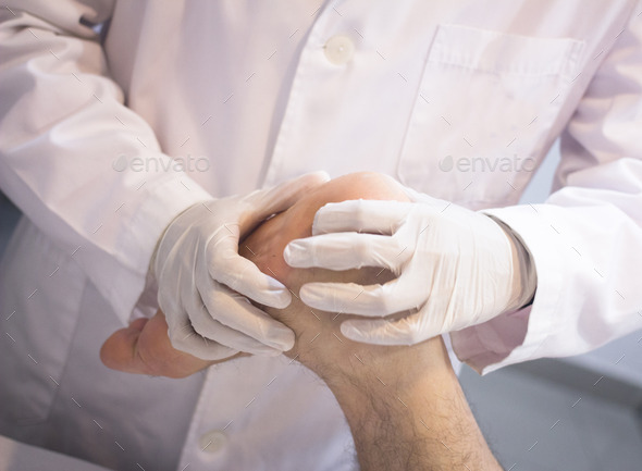 Orthopedic surgeon doctor examining patient foot