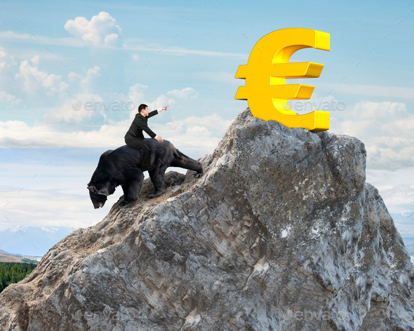 Businessman riding bear pursuing gold euro symbol on mountain peak (Misc) Photo Download