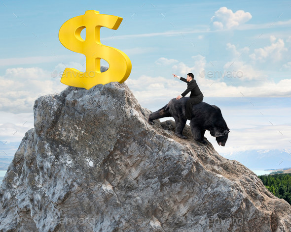 Businessman riding bear pursuing gold dollar sign on mountain peak (Misc) Photo Download