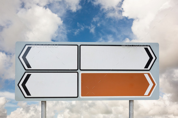 Signpost arrows with copy space against cloudy blue sky (Misc) Photo Download