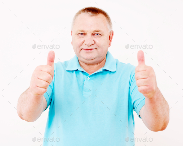 Senior man showing thumbs up over white (Misc) Photo Download