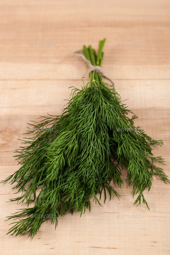 Bunch of fresh dill on a wooden.