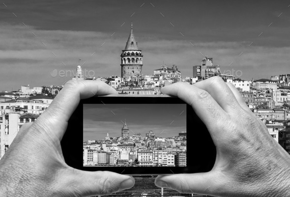 Man and woman hand capturing Beyoglu skyline skyline with smartp
