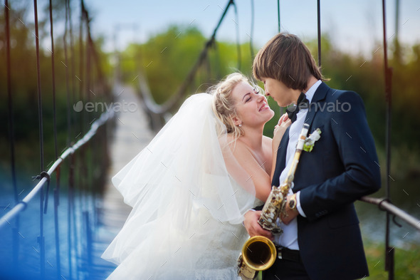 bride and groom standing on the bridge (Misc) Photo Download