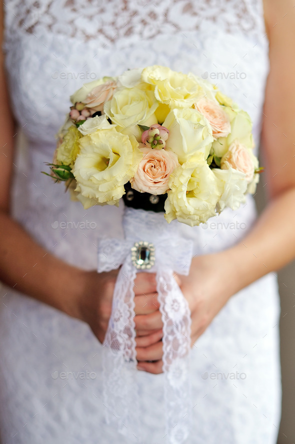 Bride is holding a bouquet in hand (Misc) Photo Download