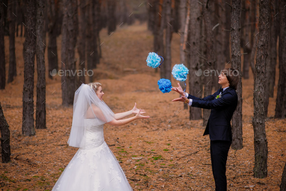 happy bride and groom walking in the autumn forest (Misc) Photo Download