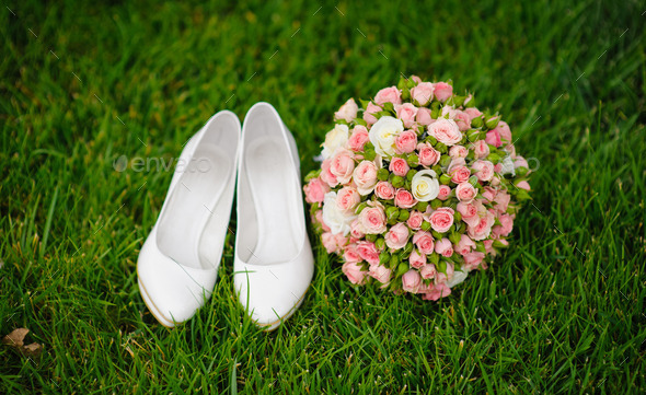 wedding bouquet and shoes lying down on green grass (Misc) Photo Download