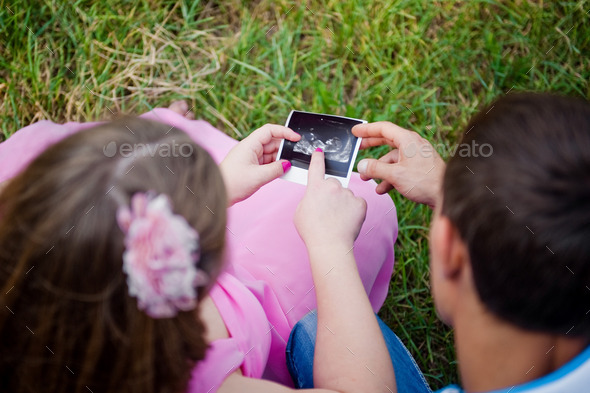 Prospective parents looking at ultrasound scan (Misc) Photo Download